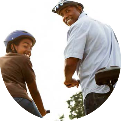 Image of a father and daughter biking