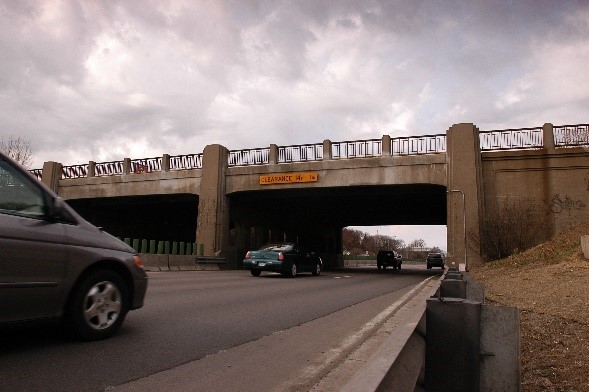 Cars driving underneath an overpass bridge